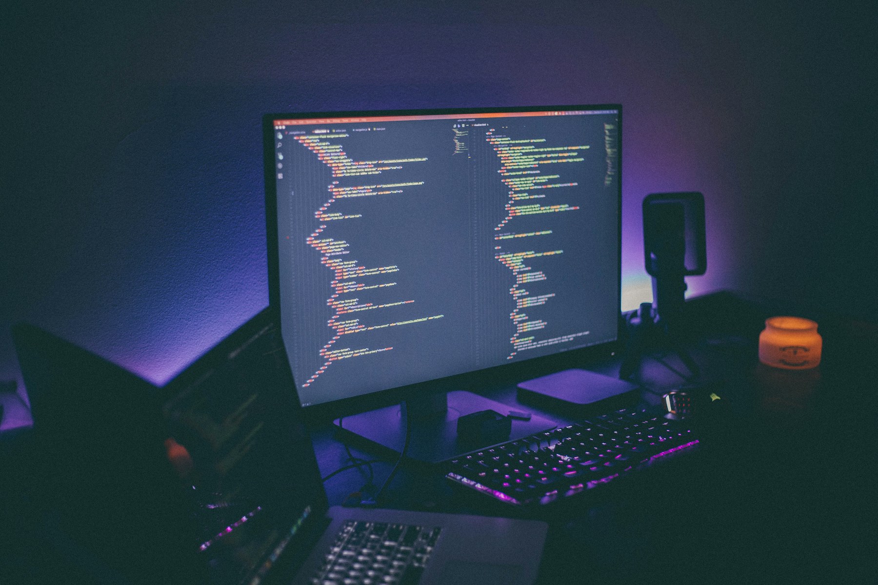 A software development workspace illuminated by code